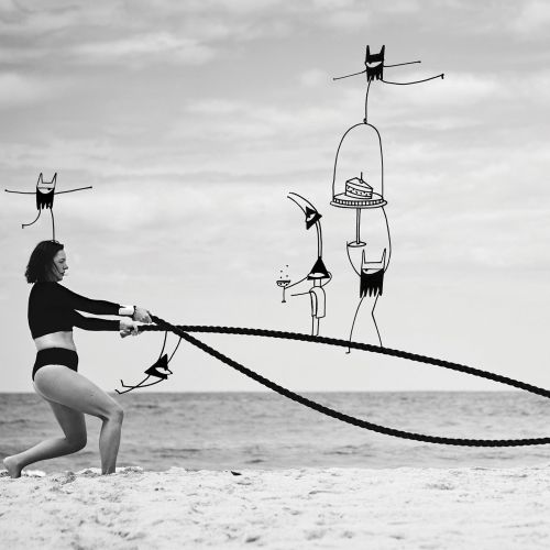 Woman exercising with battle ropes on beach, abstract figures by Nadia Flower