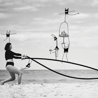 Woman exercising with battle ropes on beach, abstract figures by Nadia Flower