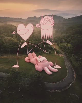 Pink abstract figure sculpture with heart shapes in green hills by Nadia Flower