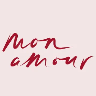 Red cursive text reading mon amour on a light background