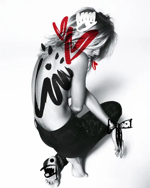 Person with abstract red and black body paint art on back and arms