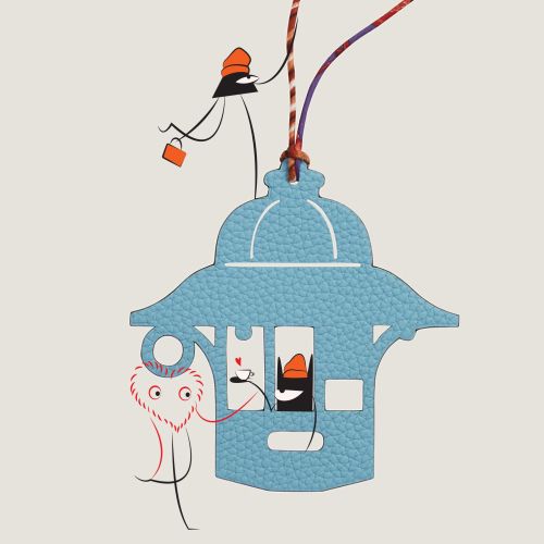 Keychain with blue house pendant and playful cartoon characters