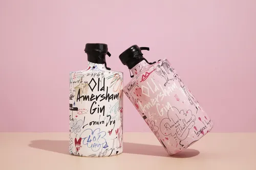 Two artistic gin bottles with handwritten designs by Nadia Flower