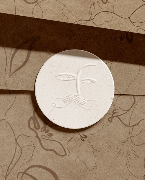 Minimalist white circular relief sculpture with abstract face by Nadia Flower