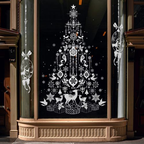 White illustrated Christmas tree with ornaments and animals on black window by Nadia Flower