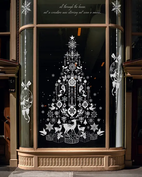 White illustrated Christmas tree with ornaments and animals on black window by Nadia Flower