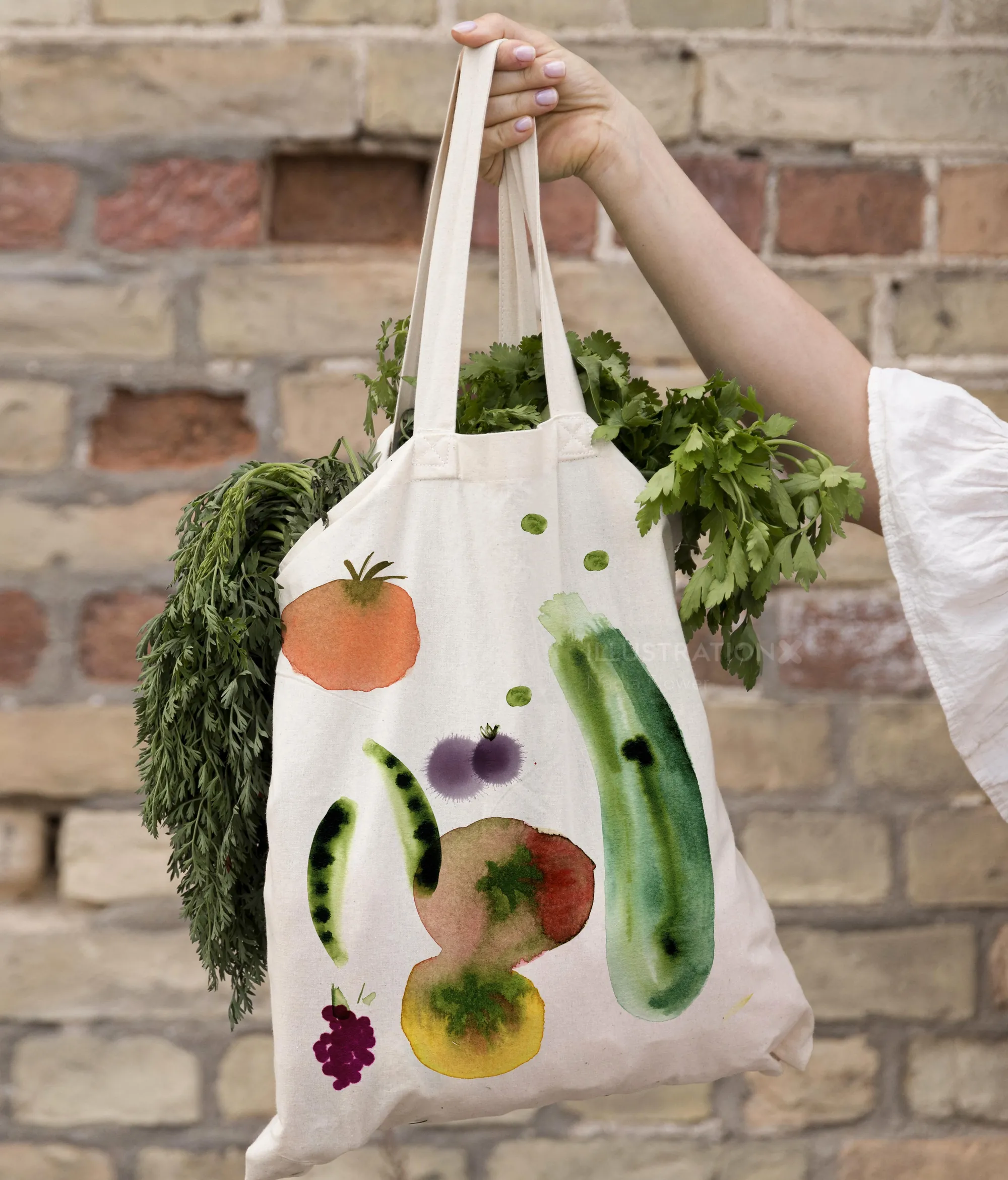 Nadia Flower’s vegetable-printed tote bag with herbs against a brick wall