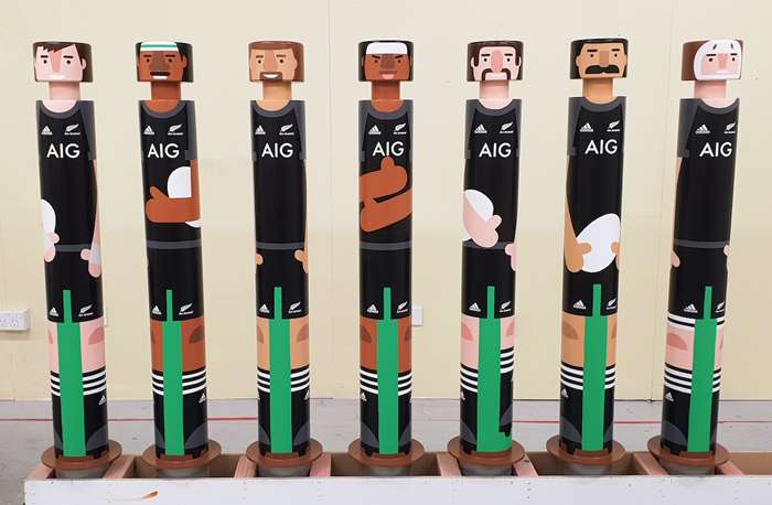 Airport staff painting on bollards