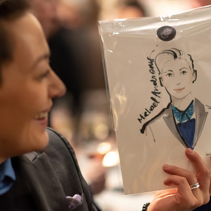 Woman showing her painting in live event